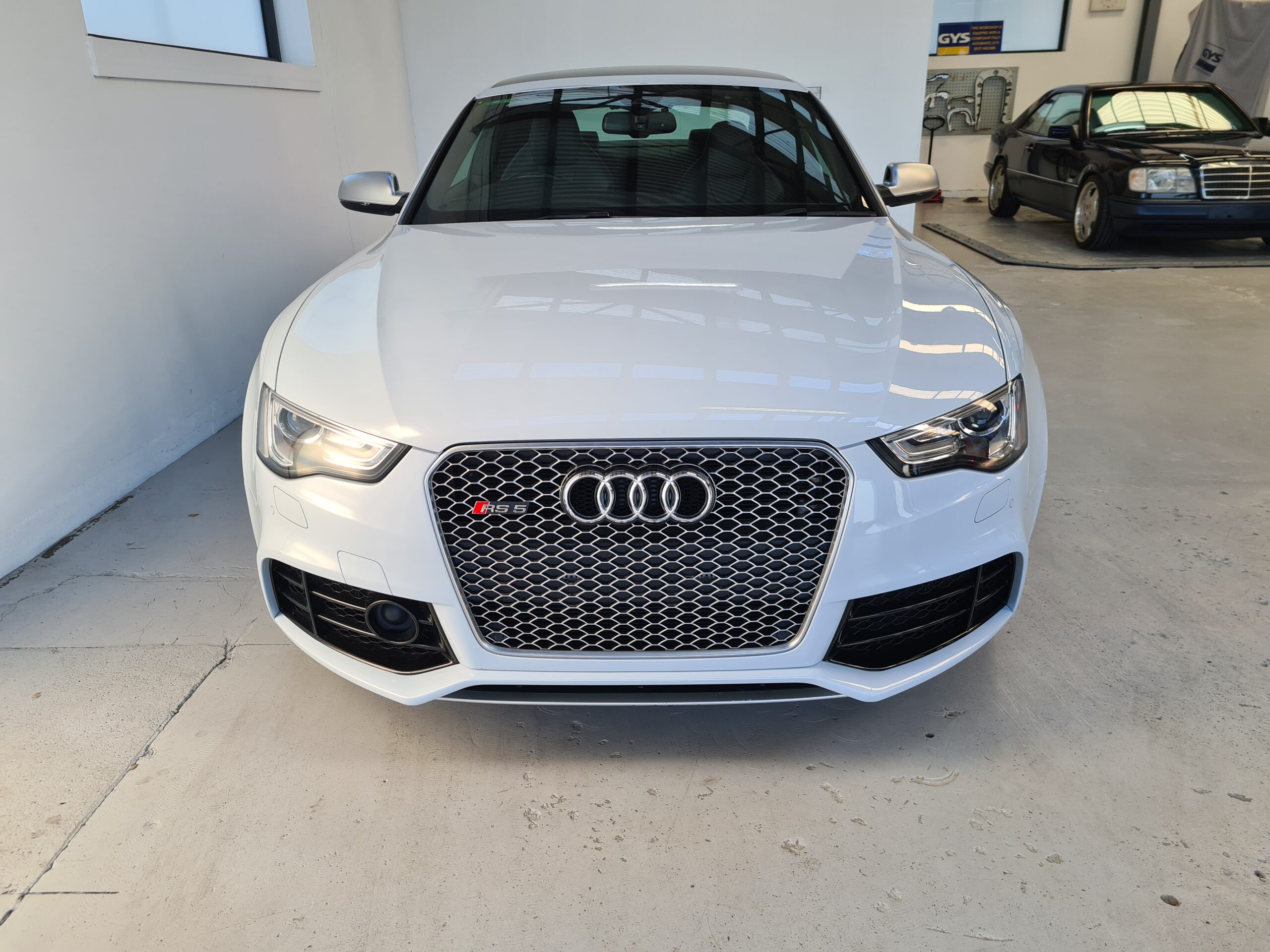 front view of cleaned and detailed audi rs5 in white after smash repair